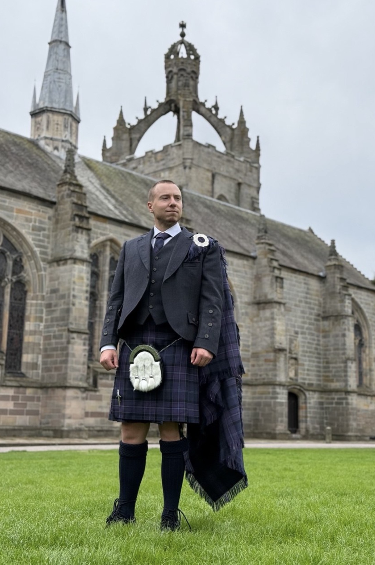 Vitalii Loboda, founder of Scotland Websites, in Highland dress outside King's College in Aberdeen